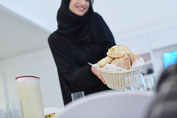 Image showing Young muslim woman serving food for iftar during Ramadan
