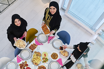 Image showing Top view of young muslim women preparing food for iftar during Ramadan