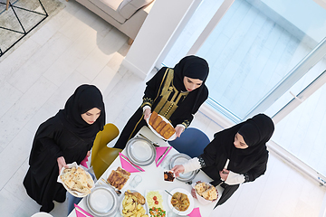 Image showing Top view of young muslim women preparing food for iftar during Ramadan