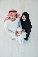 Image showing Top view of young arabian muslim family wearing traditional clothes