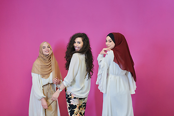 Image showing Young muslim women posing on pink background