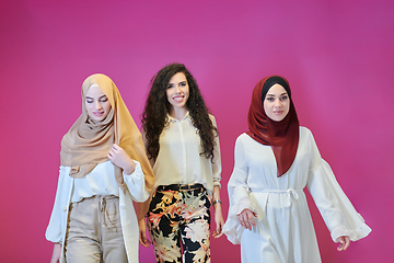 Image showing Young muslim women posing on pink background