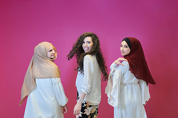 Image showing Young muslim women posing on pink background