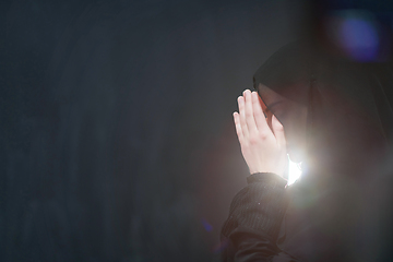 Image showing Portrait of young Muslim woman making dua