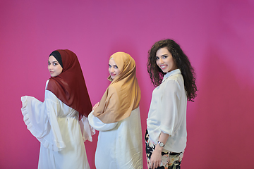 Image showing Young muslim women posing on pink background