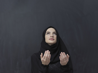 Image showing Portrait of young Muslim woman making dua