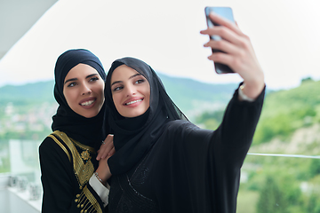 Image showing Portrait of young muslim women taking selfie on the balcony