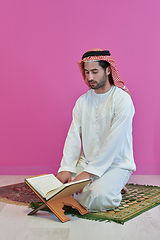 Image showing Young muslim man reading Quran during Ramadan