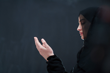 Image showing Portrait of young Muslim woman making dua