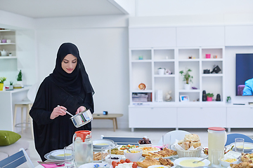 Image showing Young muslim woman serving food for iftar during Ramadan