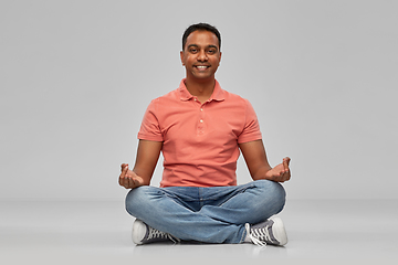 Image showing happy indian mant meditating in lotus yoga pose