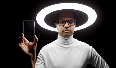 Image showing man in glasses with smartphone under illumination