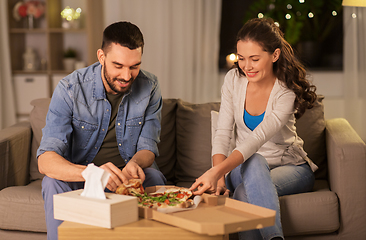 Image showing happy couple eating takeaway pizza at home