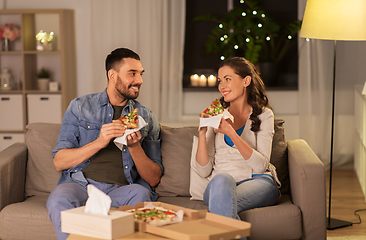 Image showing happy couple eating takeaway pizza at home