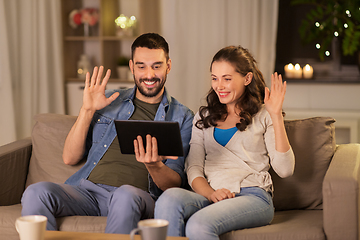 Image showing couple with tablet pc having video call at home