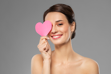 Image showing beautiful woman closing one eye with pink heart