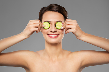 Image showing beautiful woman making eye mask of cucumbers