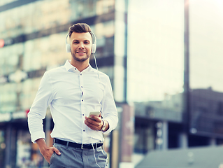 Image showing man with headphones and smartphone listening music