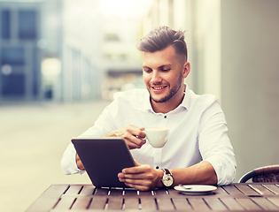 Image showing man with tablet pc and coffee at city cafe
