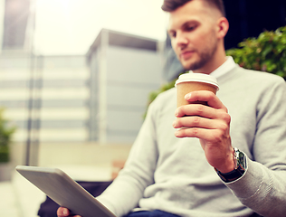 Image showing man with tablet pc and coffee cup on city street