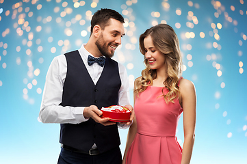 Image showing happy couple with chocolate box in shape of heart