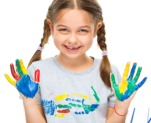 Image showing Portrait of a cute girl playing with paints