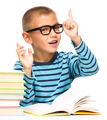 Image showing Little boy is reading a book