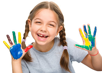 Image showing Portrait of a cute girl playing with paints