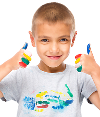 Image showing Portrait of a cute boy playing with paints