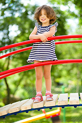 Image showing Cute little girl is playing in playground