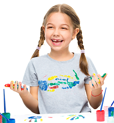 Image showing Portrait of a cute girl playing with paints