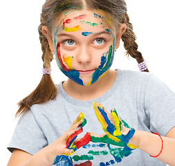 Image showing Portrait of a cute girl playing with paints