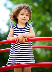 Image showing Cute little girl is playing in playground