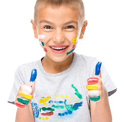 Image showing Portrait of a cute boy playing with paints