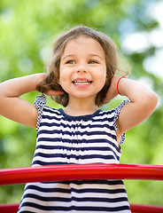 Image showing Cute little girl is playing in playground