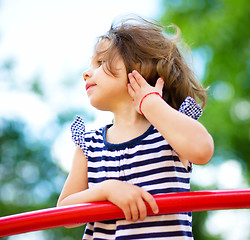 Image showing Cute little girl is playing in playground