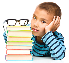 Image showing Little boy is reading a book