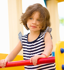 Image showing Cute little girl is playing in playground