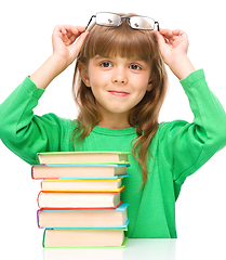 Image showing Little girl is reading a book