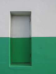 Image showing door on a white and green building