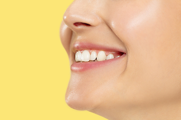 Image showing Close up shot of young woman on yellow background