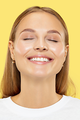 Image showing Caucasian young woman\'s close up shot on yellow background