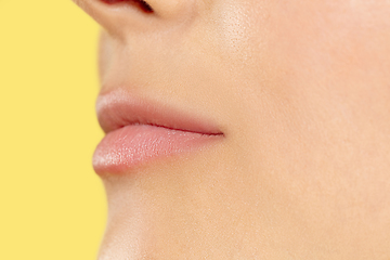 Image showing Close up shot of young woman on yellow background