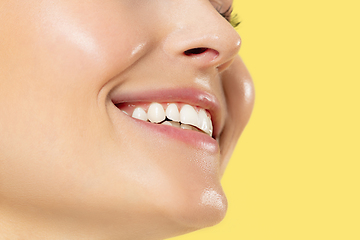 Image showing Close up shot of young woman on yellow background