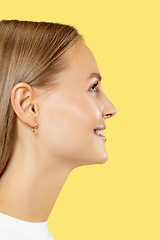 Image showing Caucasian young woman\'s close up shot on yellow background