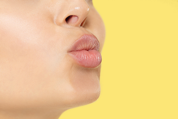 Image showing Close up shot of young woman on yellow background