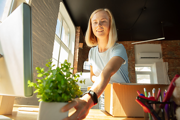 Image showing A young businesswoman moving in office, getting new work place