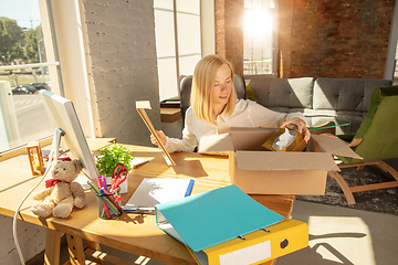 Image showing A young businesswoman moving in office, getting new work place