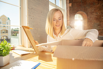 Image showing A young businesswoman moving in office, getting new work place