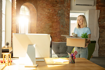 Image showing A young businesswoman moving in office, getting new work place